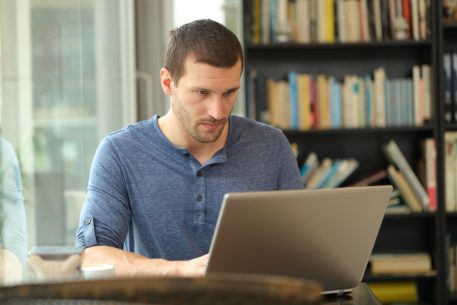 Man at laptop looking focused as he creates Teachable courses