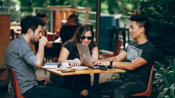 Entrepreneurs sitting at a cafe designing their digital marketing strategy